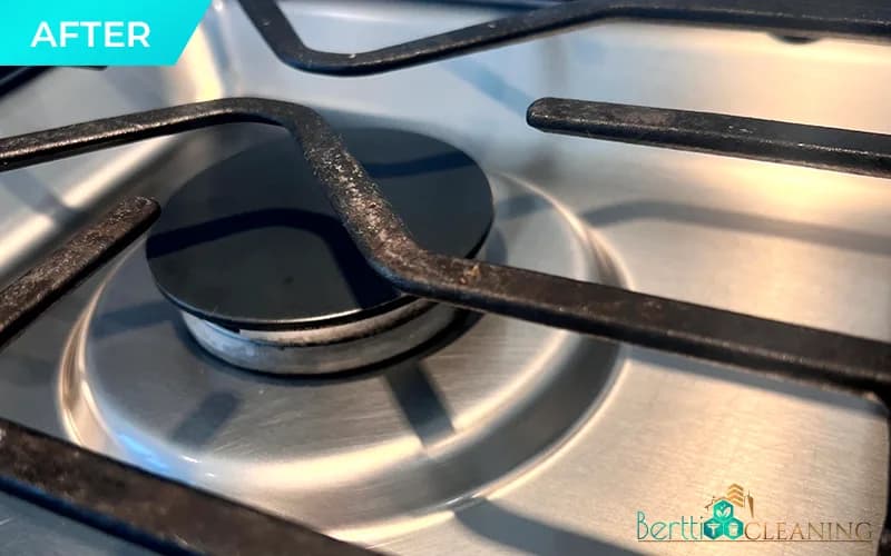 After: Gas burner close-up, crumbs and grease on the grate