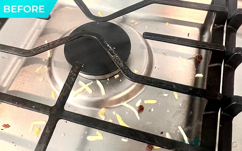Before: Gas burner close-up, crumbs and grease on the grate